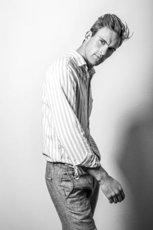 Elegant young handsome man in classic shirt. Black-white portrait.の写真素材