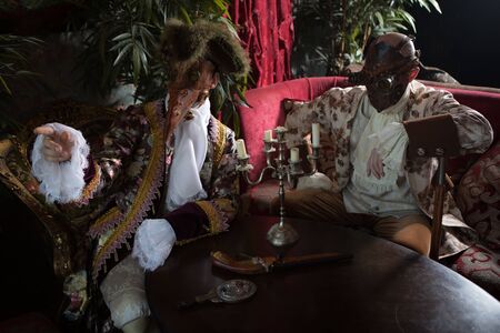 Actors in Steam punk masks and antique costumes indoor.の写真素材