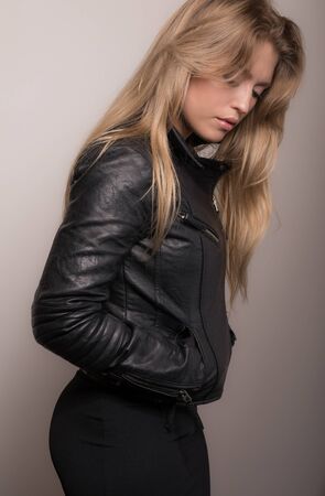 Young beautiful stylish girl posing in studio.の写真素材