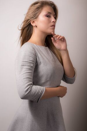 Young beautiful stylish girl posing in studio.の写真素材