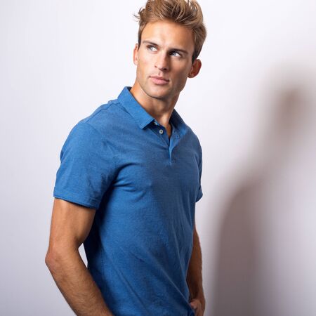 Elegant young handsome man in stylish blue shirt.の写真素材