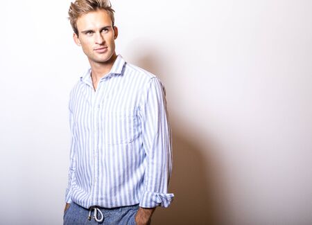 Elegant young handsome man in stylish blue shirt.の写真素材