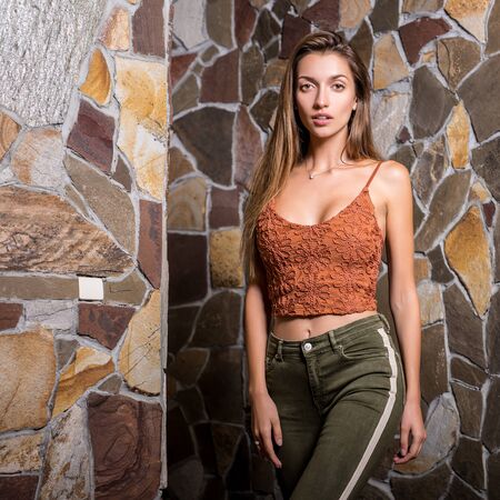 Young beauty woman against natural stone background.の写真素材