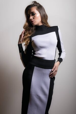 Young beautiful stylish girl posing in studio.の写真素材