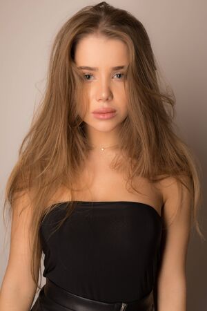 Young beautiful stylish girl posing in studio.の写真素材