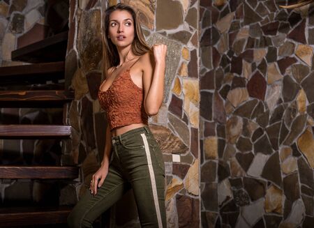 Young beauty woman against natural stone background.の写真素材