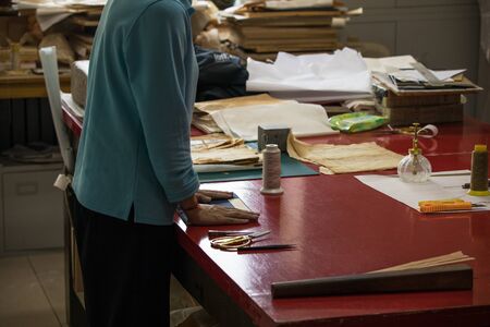 BEIJING, Ð¡HINA - JUNE 01, 2019: Traditional Chinese book and calligraphy restorer laboratory. Master hands at work close-up.のeditorial素材