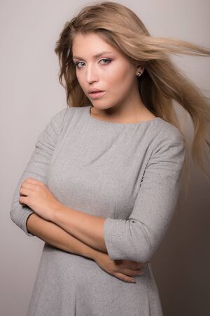 Young beautiful stylish girl posing in studio.の写真素材