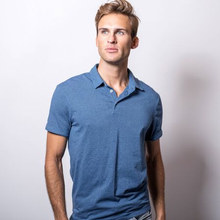 Elegant young handsome man in stylish blue shirt.の写真素材