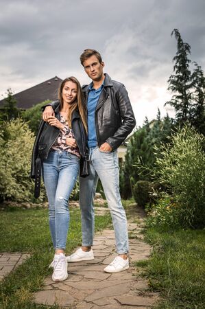 Young beautiful couple in garden near house.の写真素材