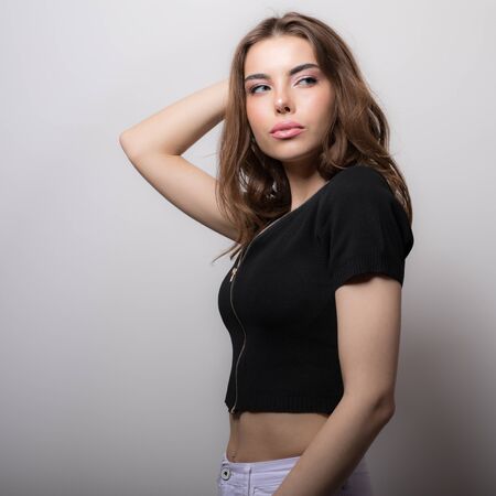 Young beautiful stylish girl posing in studio.の写真素材