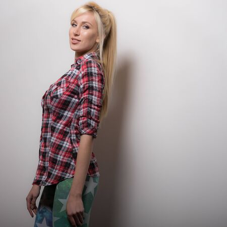 Young beautiful stylish girl posing in studio.の写真素材
