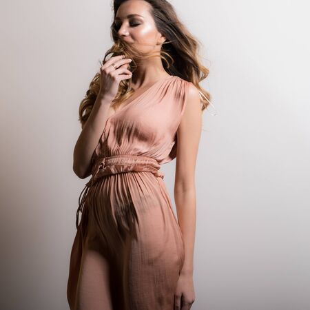 Young beautiful stylish girl posing in studio.の写真素材