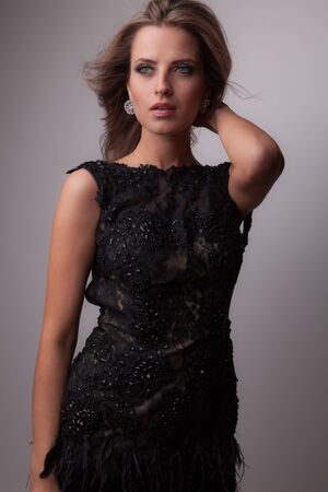 Young beautiful stylish girl posing in studio.の写真素材