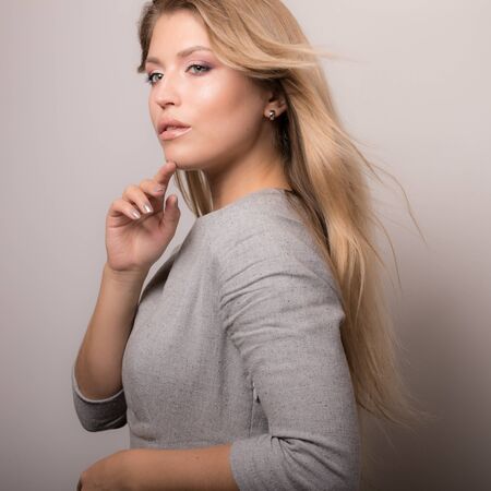 Young beautiful stylish girl posing in studio.の写真素材