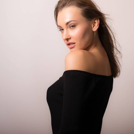 Young beautiful stylish girl posing in studio.の写真素材