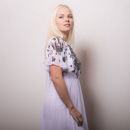 Young beautiful stylish girl posing in studio.の写真素材