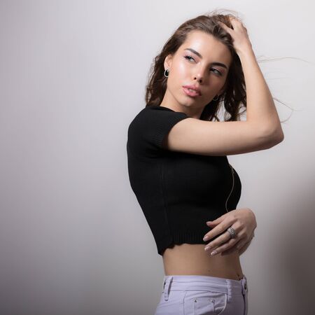 Young beautiful stylish girl posing in studio.の写真素材
