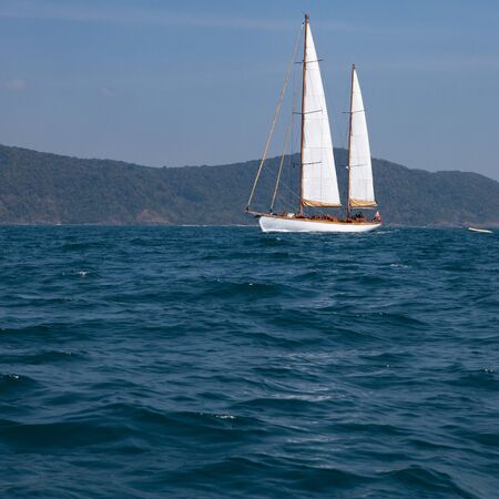 Landscape of tropical island with moving boat.