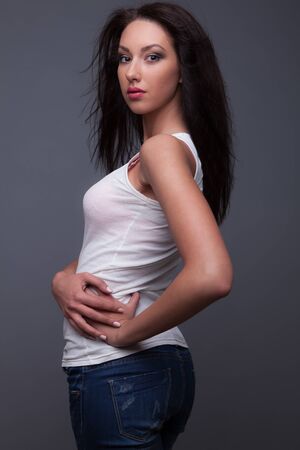 Young beautiful stylish girl posing in studio.の写真素材