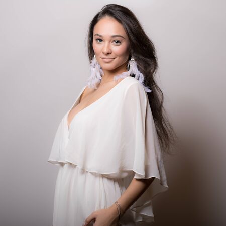 Young beautiful stylish girl posing in studio.の写真素材