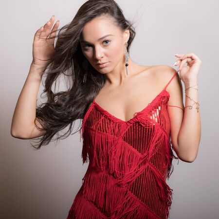 Young beautiful stylish girl posing in studio.の写真素材