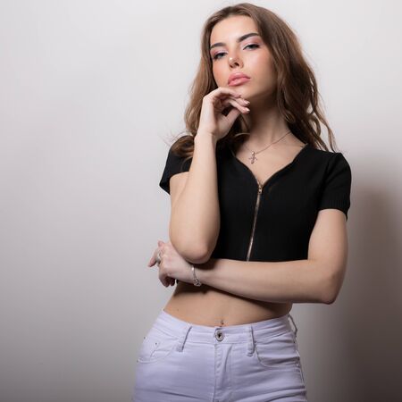 Young beautiful stylish girl posing in studio.の写真素材