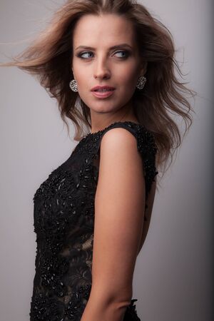 Young beautiful stylish girl posing in studio.の写真素材