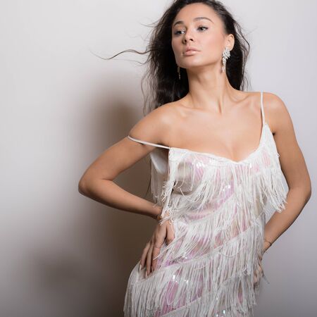 Young beautiful stylish girl posing in studio.の写真素材