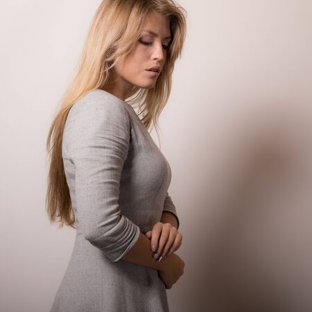 Young beautiful stylish girl posing in studio.の写真素材