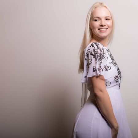 Young beautiful stylish girl posing in studio.の写真素材