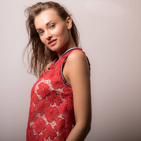 Young beautiful stylish girl posing in studio.の写真素材