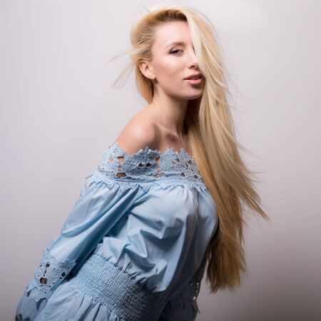 Young beautiful stylish girl posing in studio.の写真素材