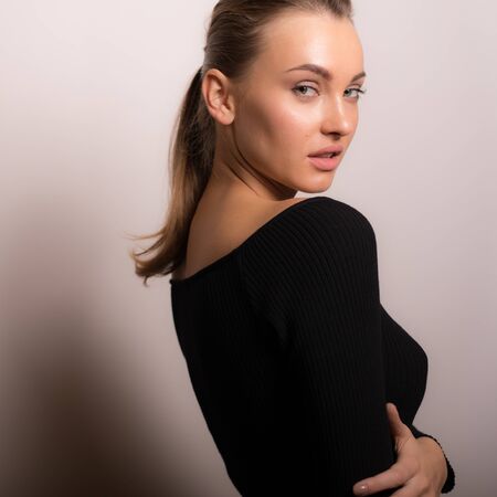 Young beautiful stylish girl posing in studio.の写真素材