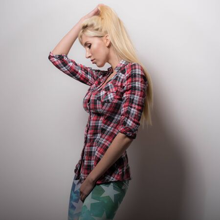 Young beautiful stylish girl posing in studio.の写真素材