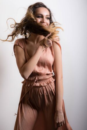 Young beautiful stylish girl posing in studio.の写真素材