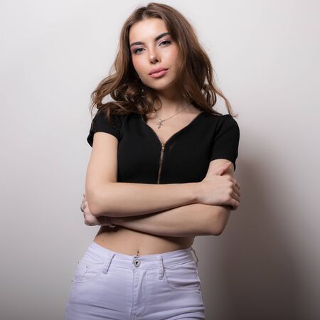 Young beautiful stylish girl posing in studio.の写真素材