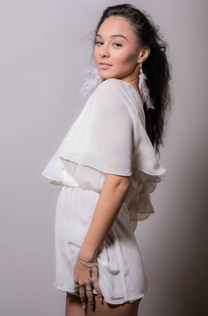Young beautiful stylish girl posing in studio.の写真素材