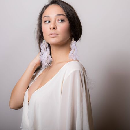 Young beautiful stylish girl posing in studio.の写真素材
