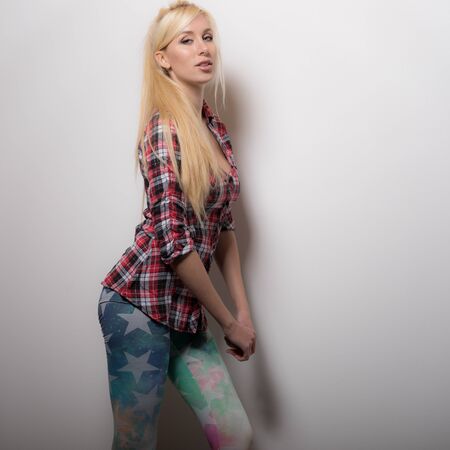 Young beautiful stylish girl posing in studio.の写真素材