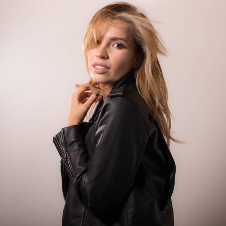 Young beautiful stylish girl posing in studio.の写真素材