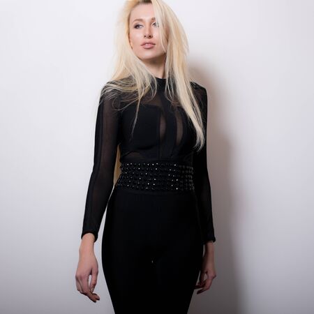 Young beautiful stylish girl posing in studio.の写真素材