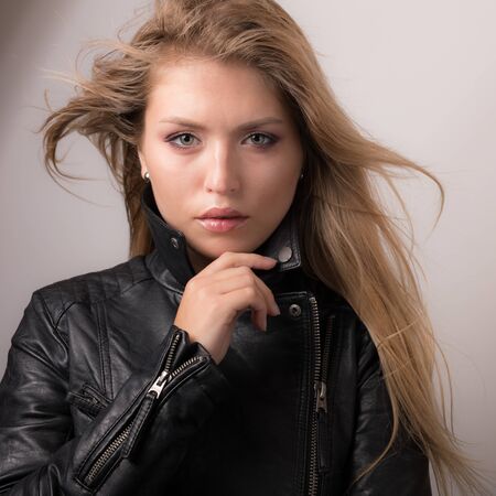 Young beautiful stylish girl posing in studio.の写真素材