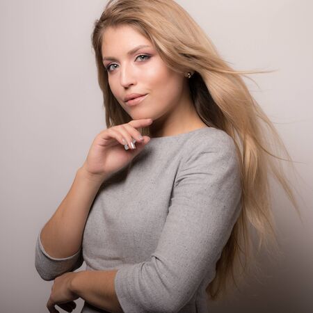 Young beautiful stylish girl posing in studio.の写真素材