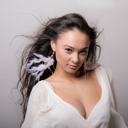 Young beautiful stylish girl posing in studio.の写真素材