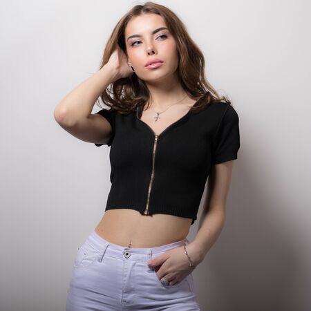 Young beautiful stylish girl posing in studio.の写真素材
