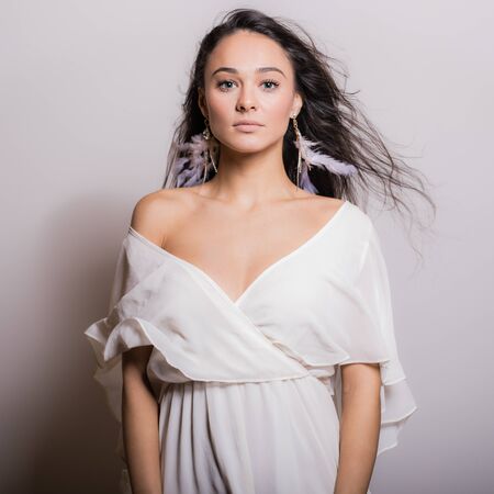 Young beautiful stylish girl posing in studio.の写真素材