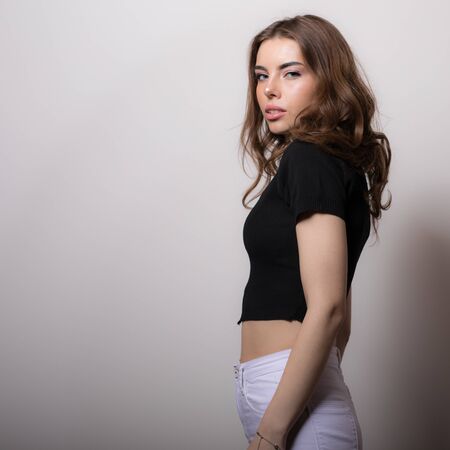 Young beautiful stylish girl posing in studio.の写真素材