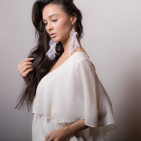 Young beautiful stylish girl posing in studio.の写真素材