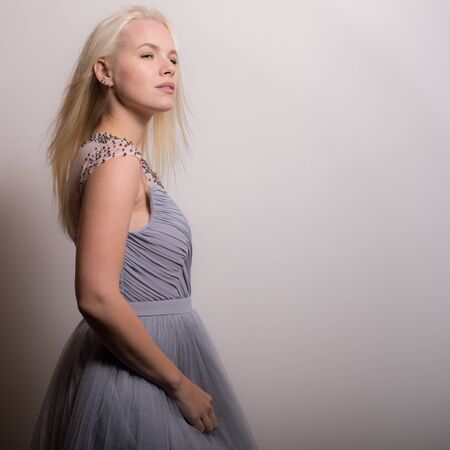 Young beautiful stylish girl posing in studio.の写真素材